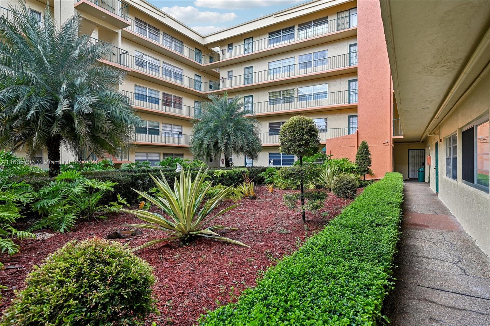 a view of a tall building with a garden