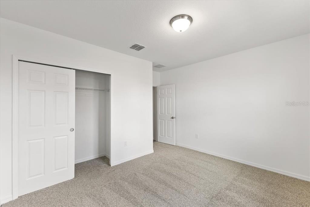 an empty room with closet area