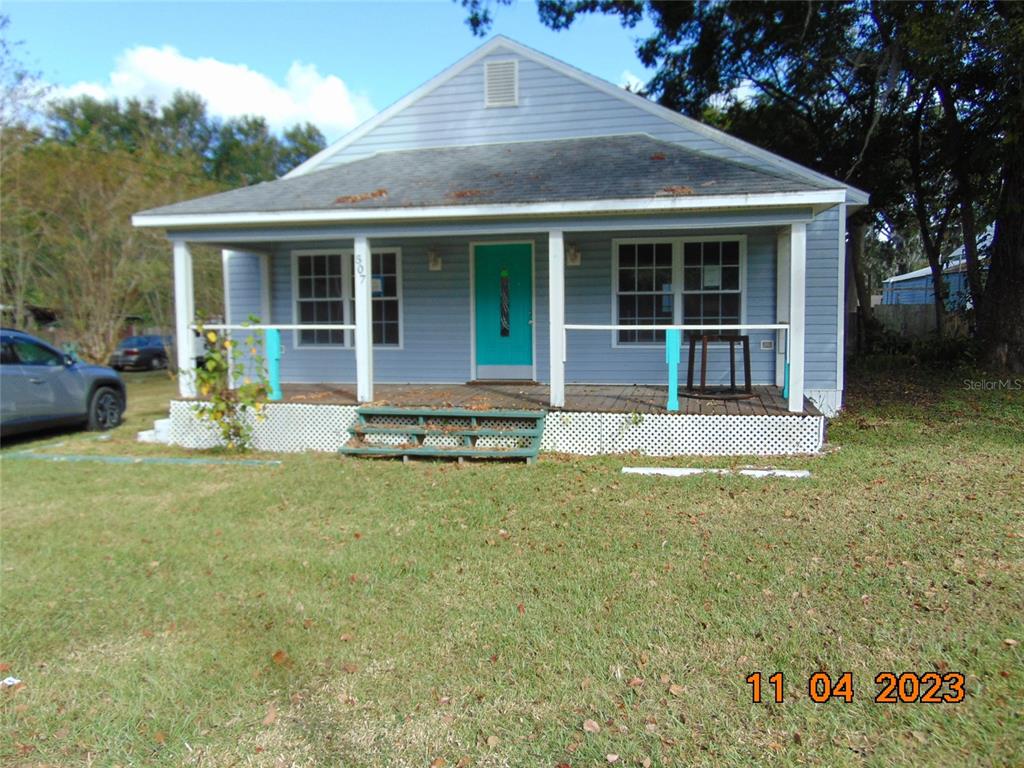 a front view of a house with a garden and porch