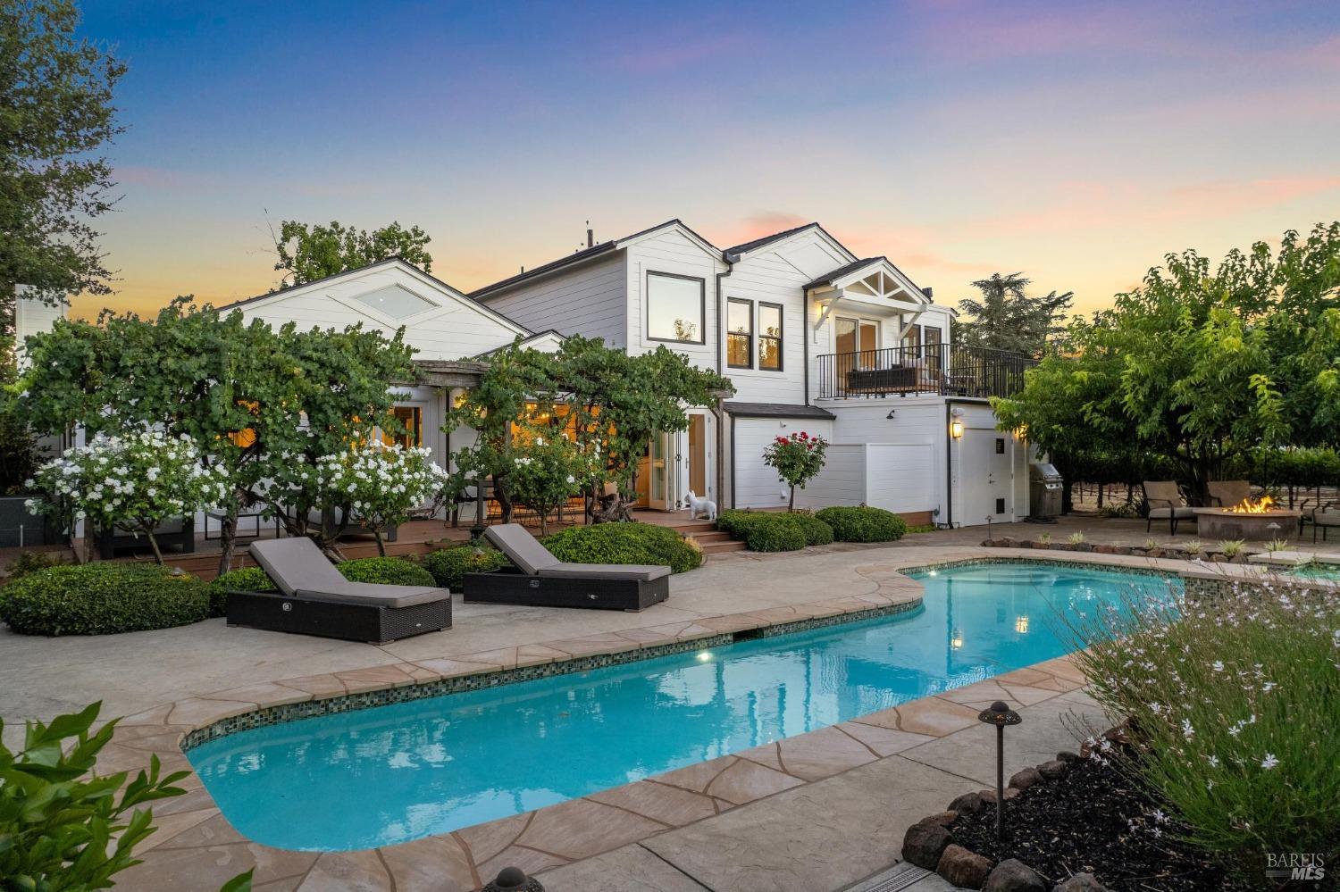 a front view of a house with swimming pool having outdoor seating