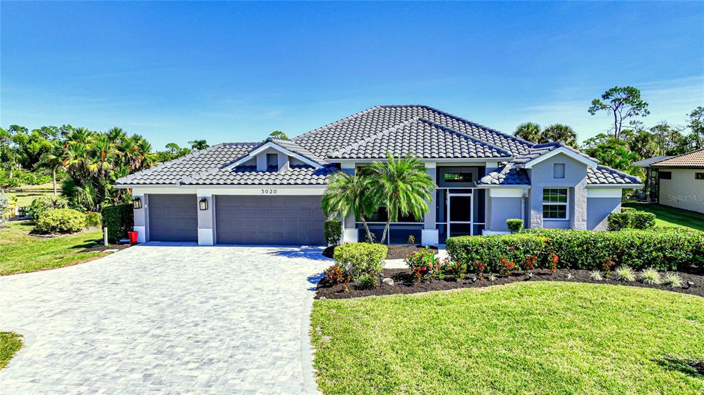 a front view of a house with garden