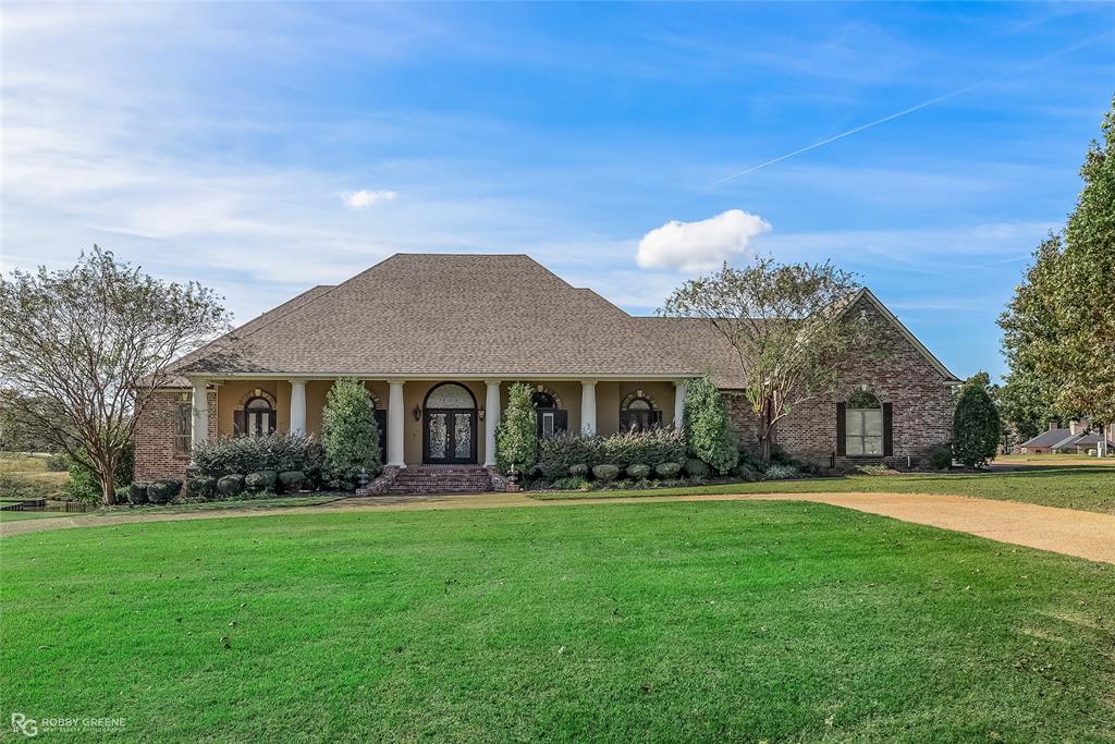 a front view of house with yard and green space