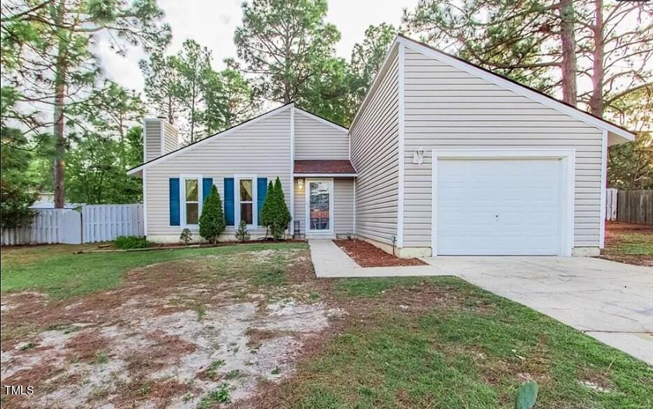 a view of a house with yard and tree s