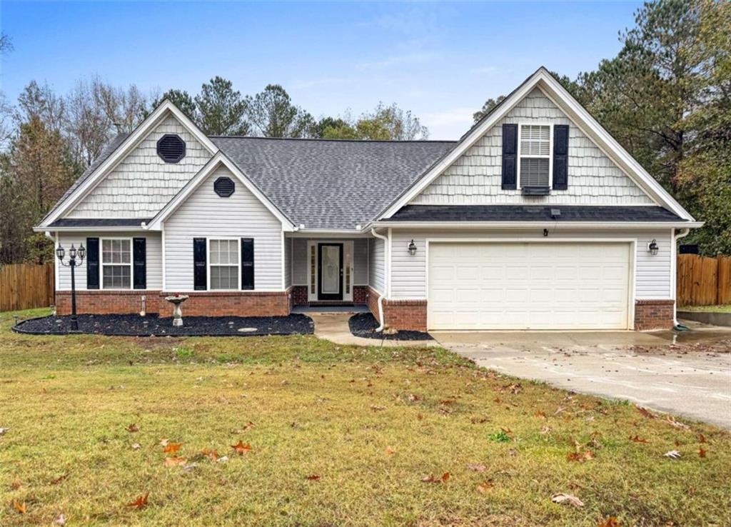 a front view of a house with a yard outdoor seating and garage