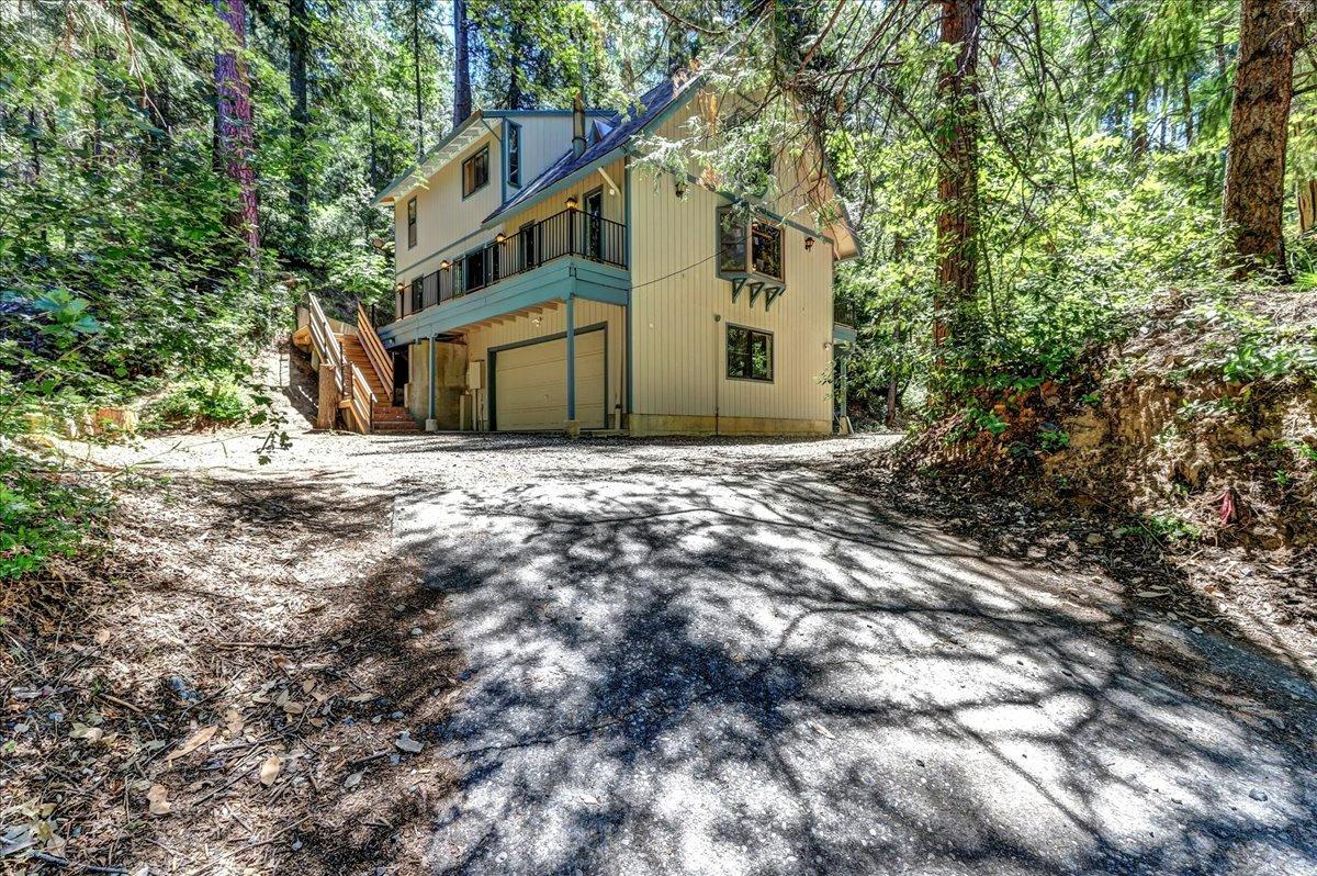 a house that has a tree in front of it