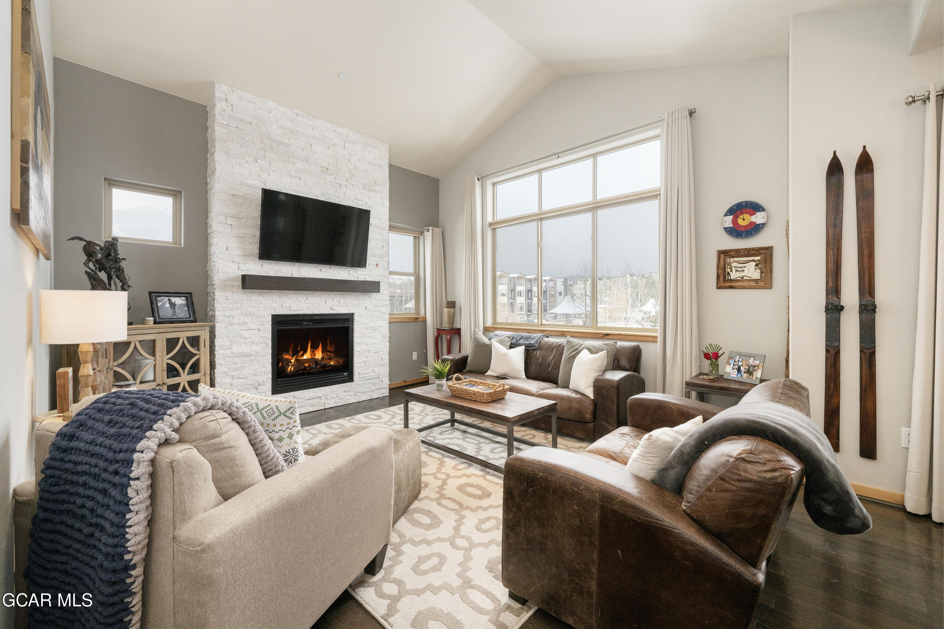 a living room with furniture fireplace and flat screen tv