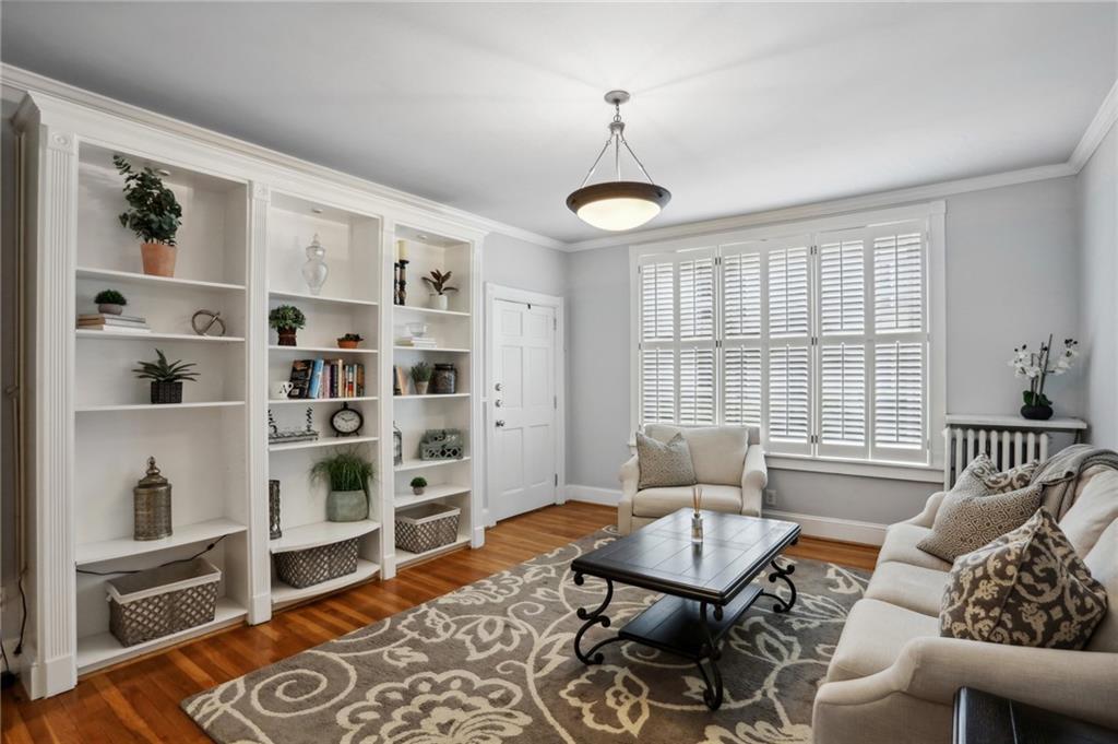 a living room with furniture cabinets and a window