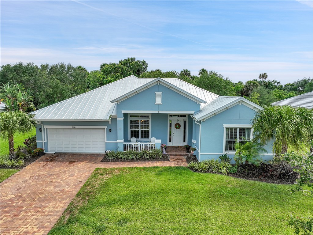 a front view of house with yard and green space