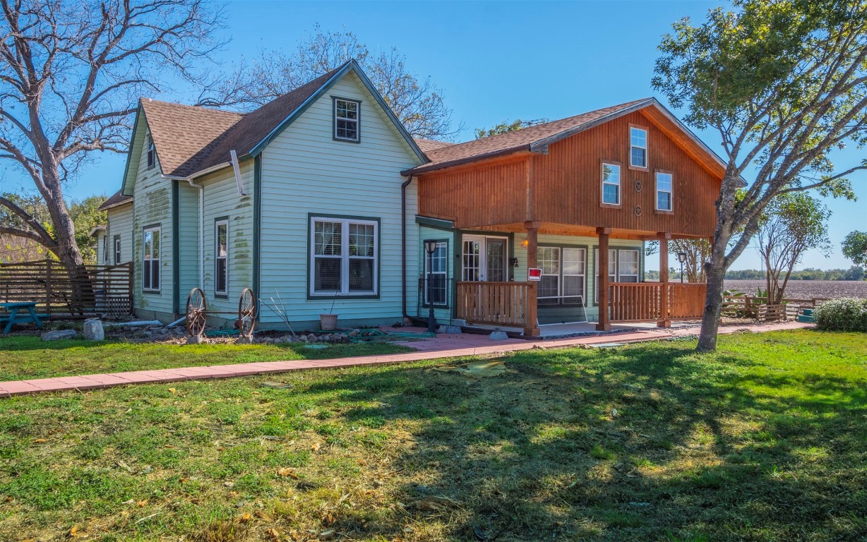 a view of a house with a yard and sitting area