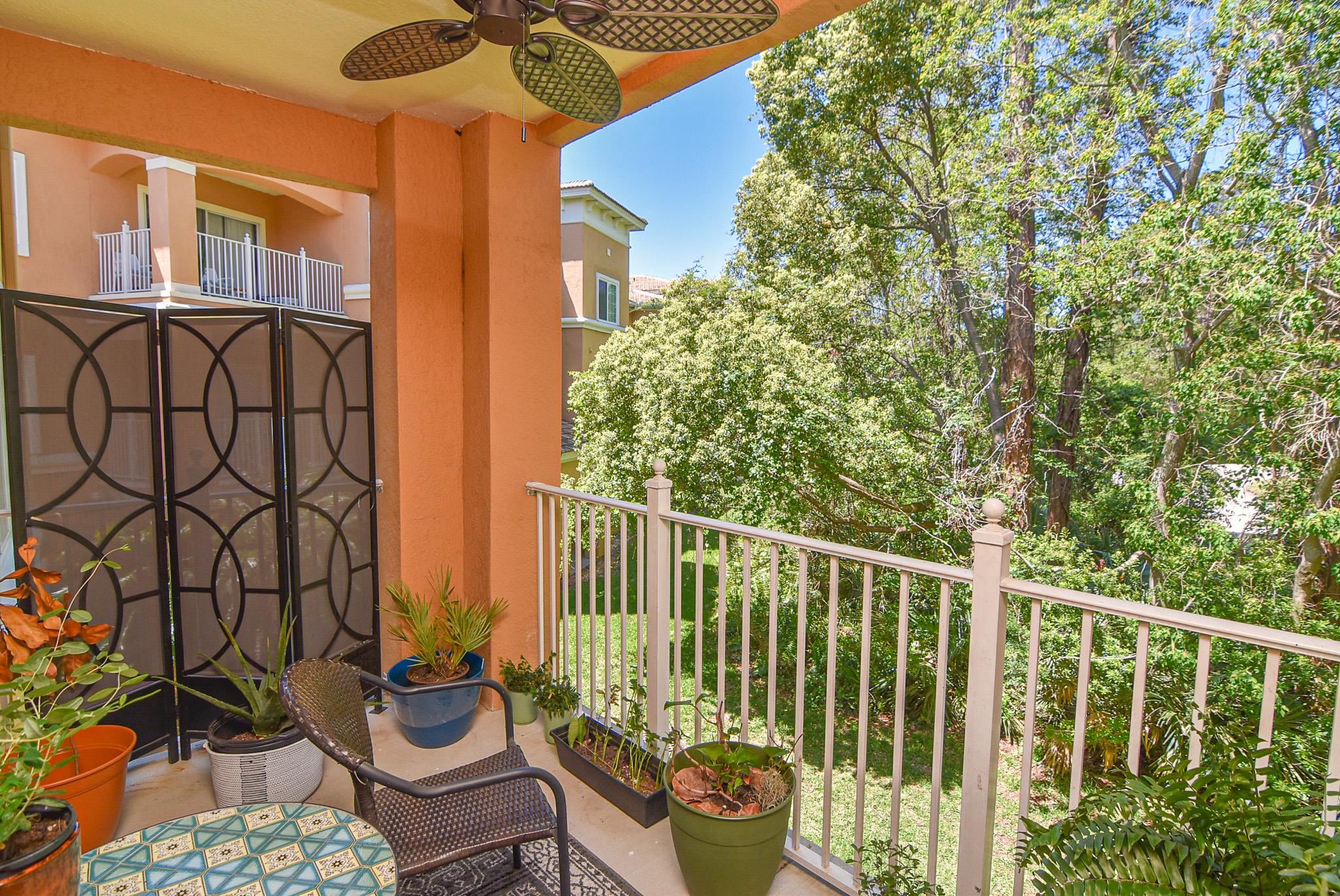 a view of a balcony with chair and potted plants