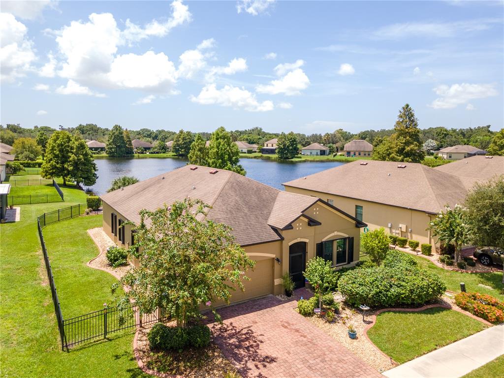 a aerial view of a house with a yard basket ball court and outdoor seating