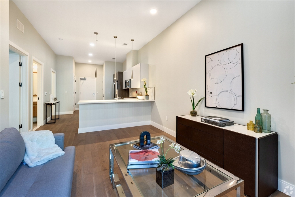 a living room with furniture and wooden floor