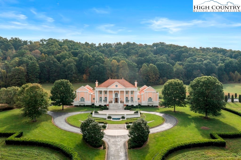 an aerial view of a house having swimming pool garden and patio