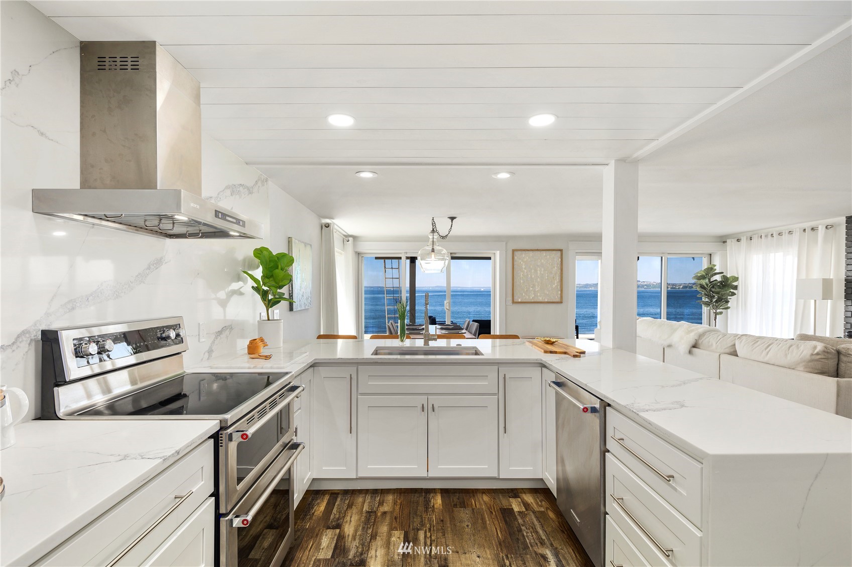 a kitchen that has a sink and a stove in it