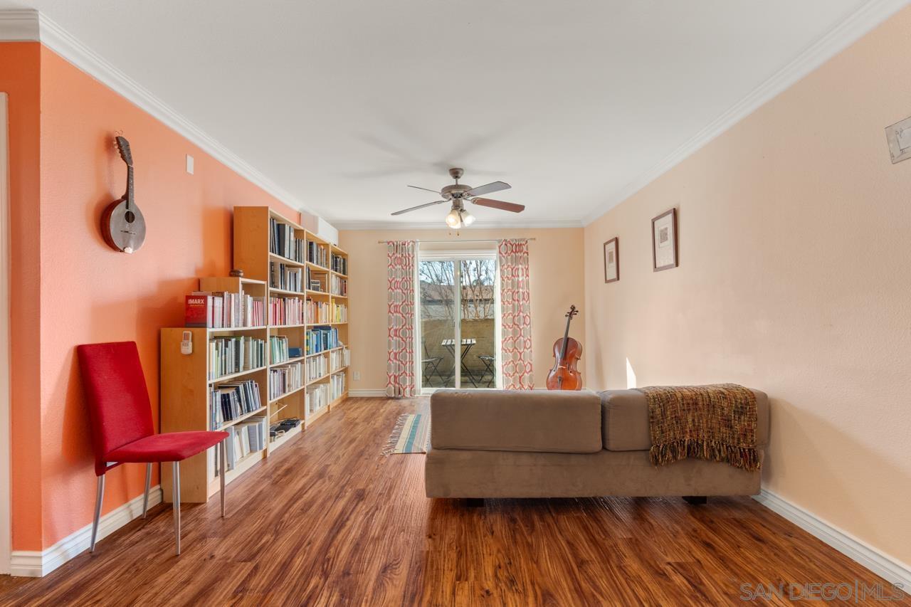 a living room with furniture and a book shelf