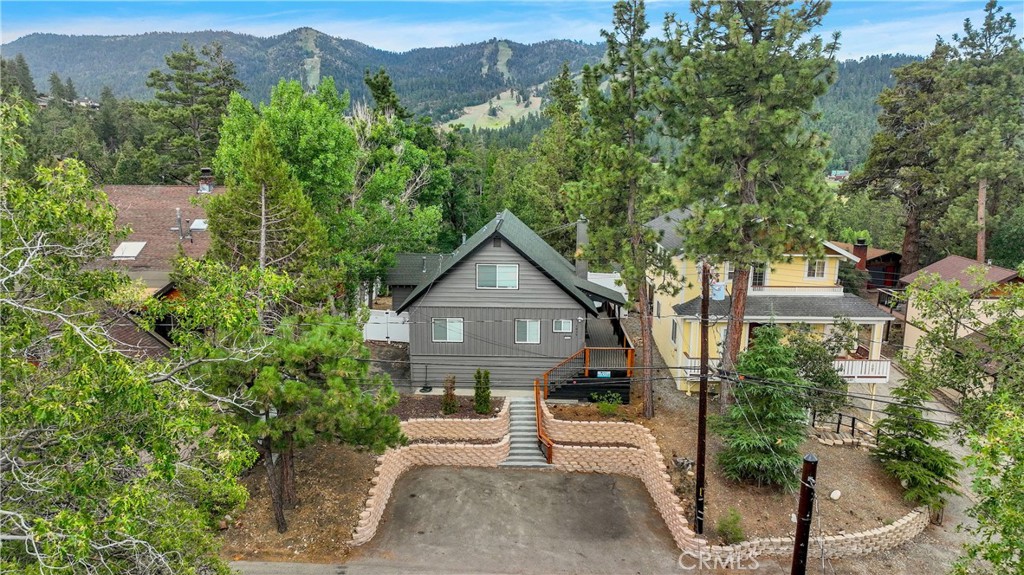 an aerial view of a house with a yard and balcony