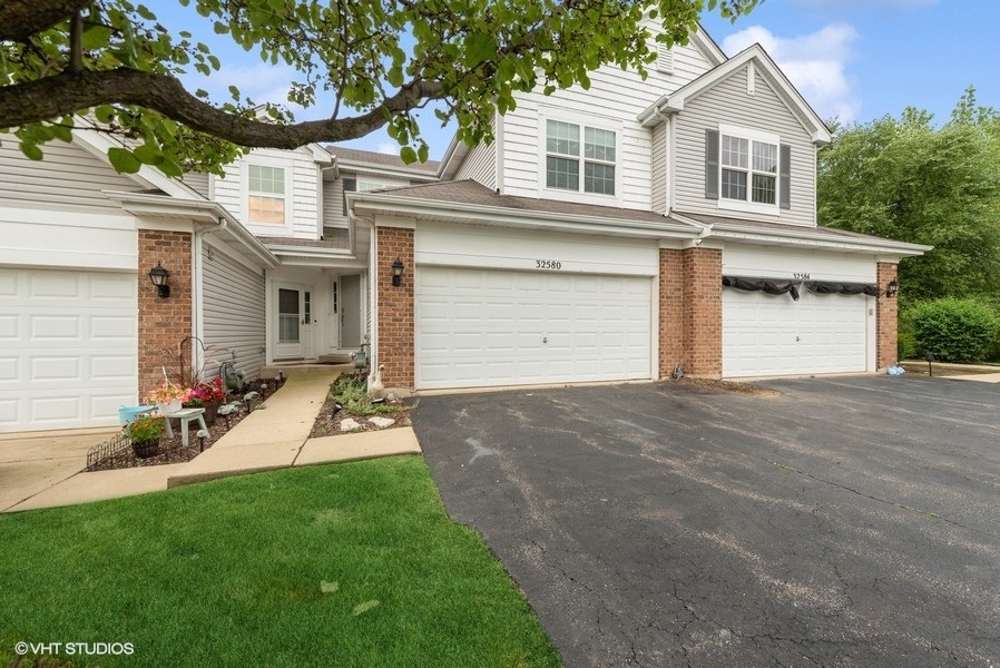 a front view of a house with a yard and garage