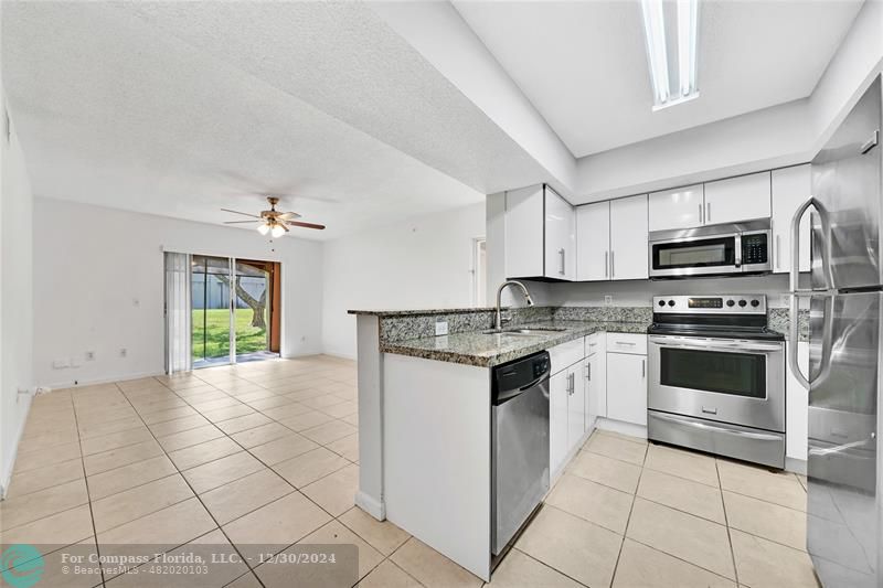 a kitchen with a stove a sink and a microwave