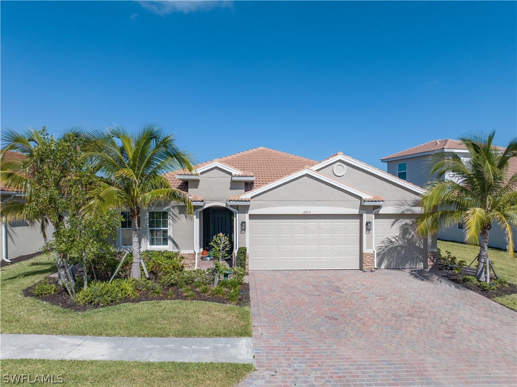 a front view of a house with a yard and garage