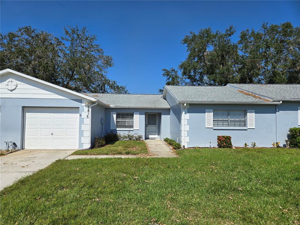 a front view of a house with a yard and garage