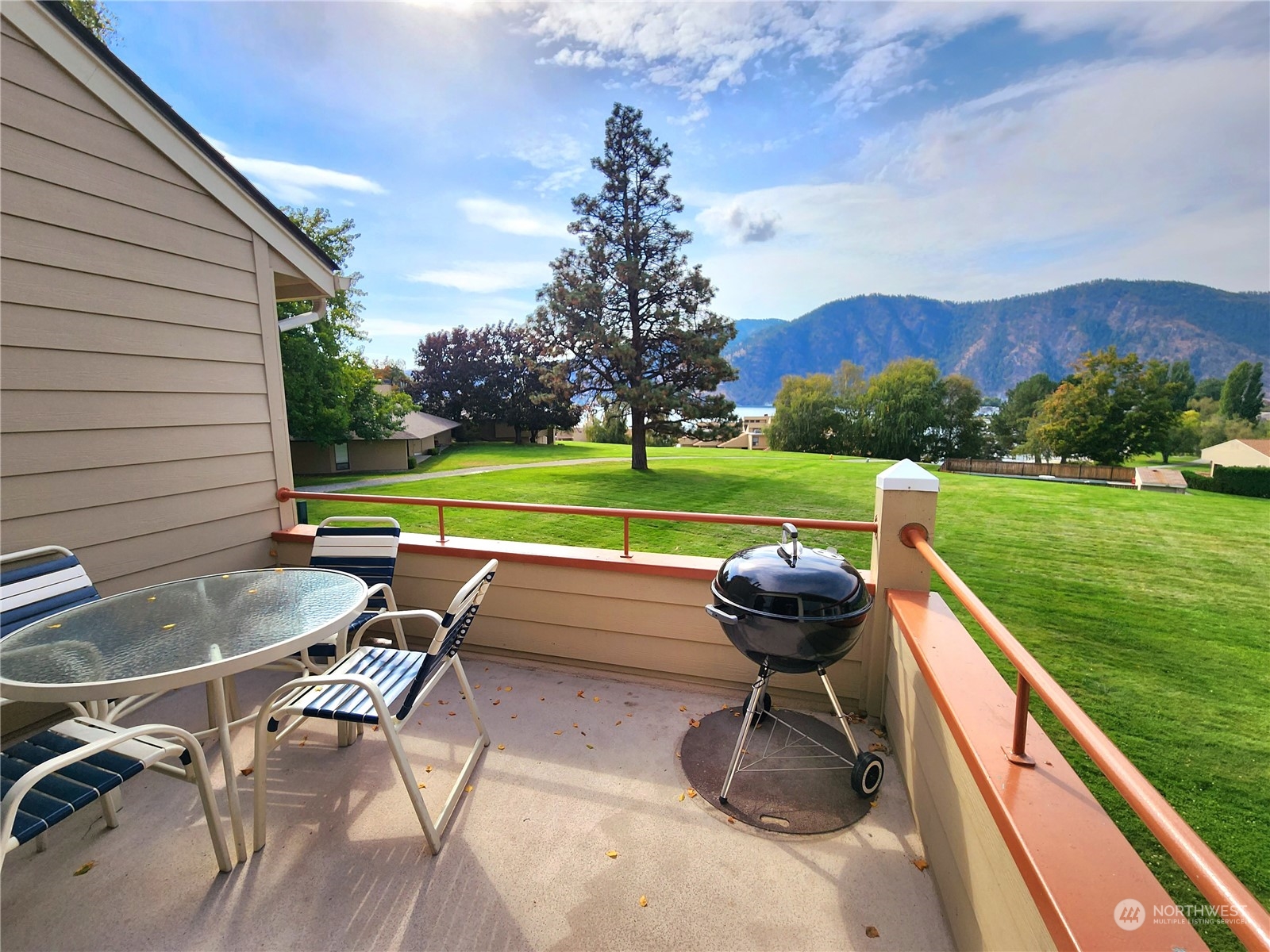 a view of a backyard with sitting area