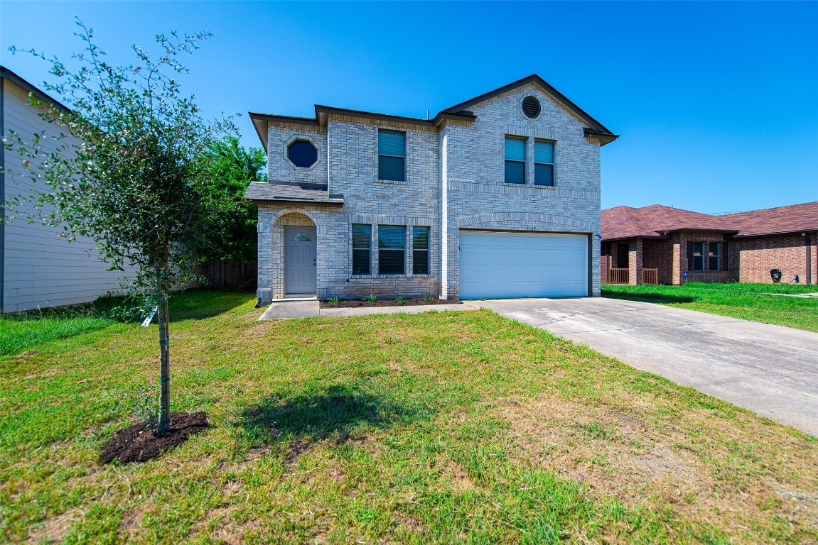 a front view of a house with a yard