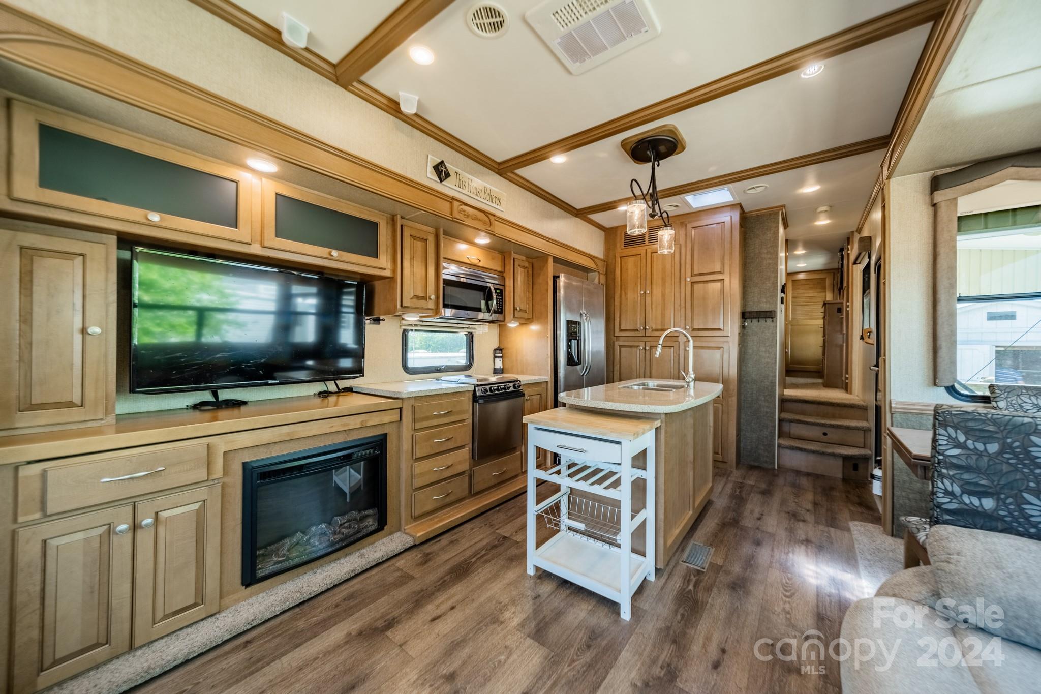 a kitchen with a stove a sink and a microwave