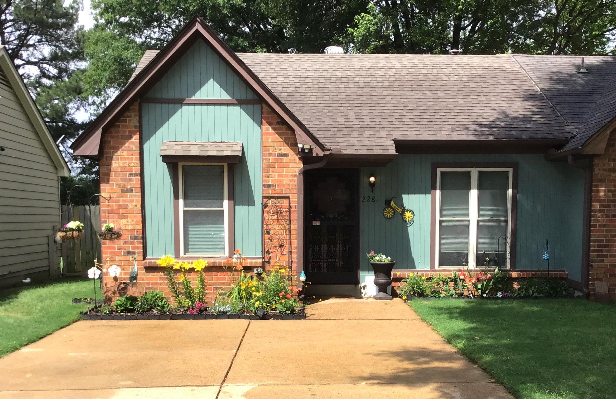 a front view of a house with garden