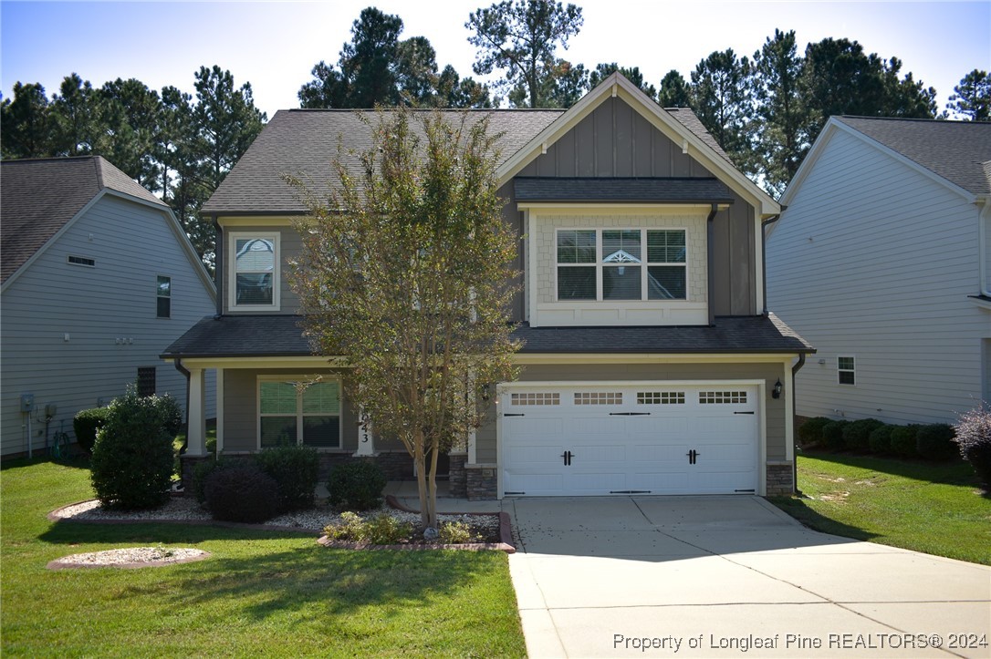 a front view of a house with a yard garage and outdoor seating