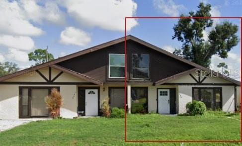 a front view of a house with a yard and porch