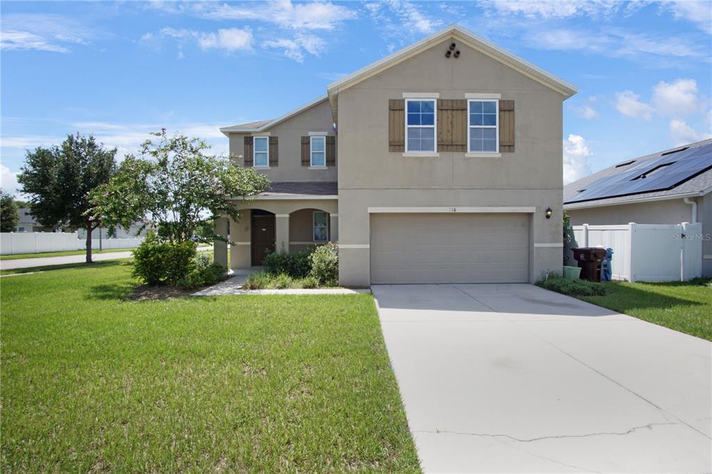 a front view of house with yard and green space