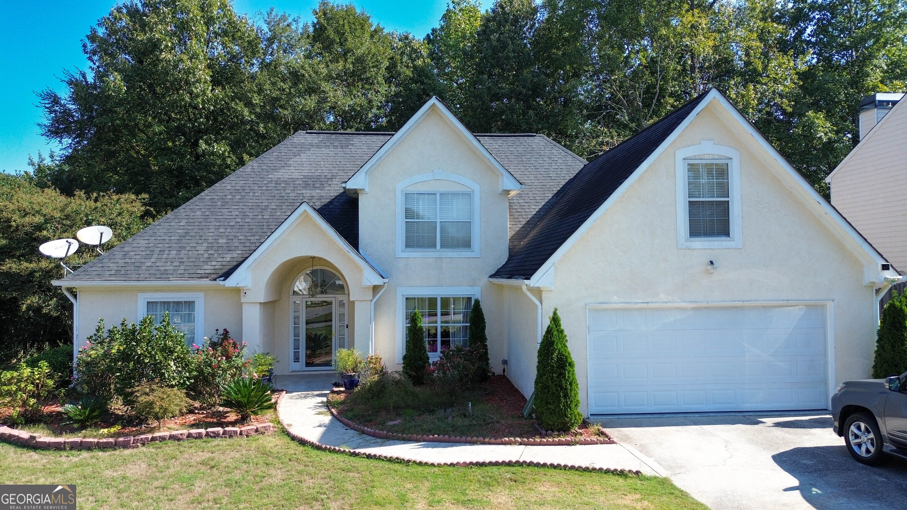 a front view of a house with garden