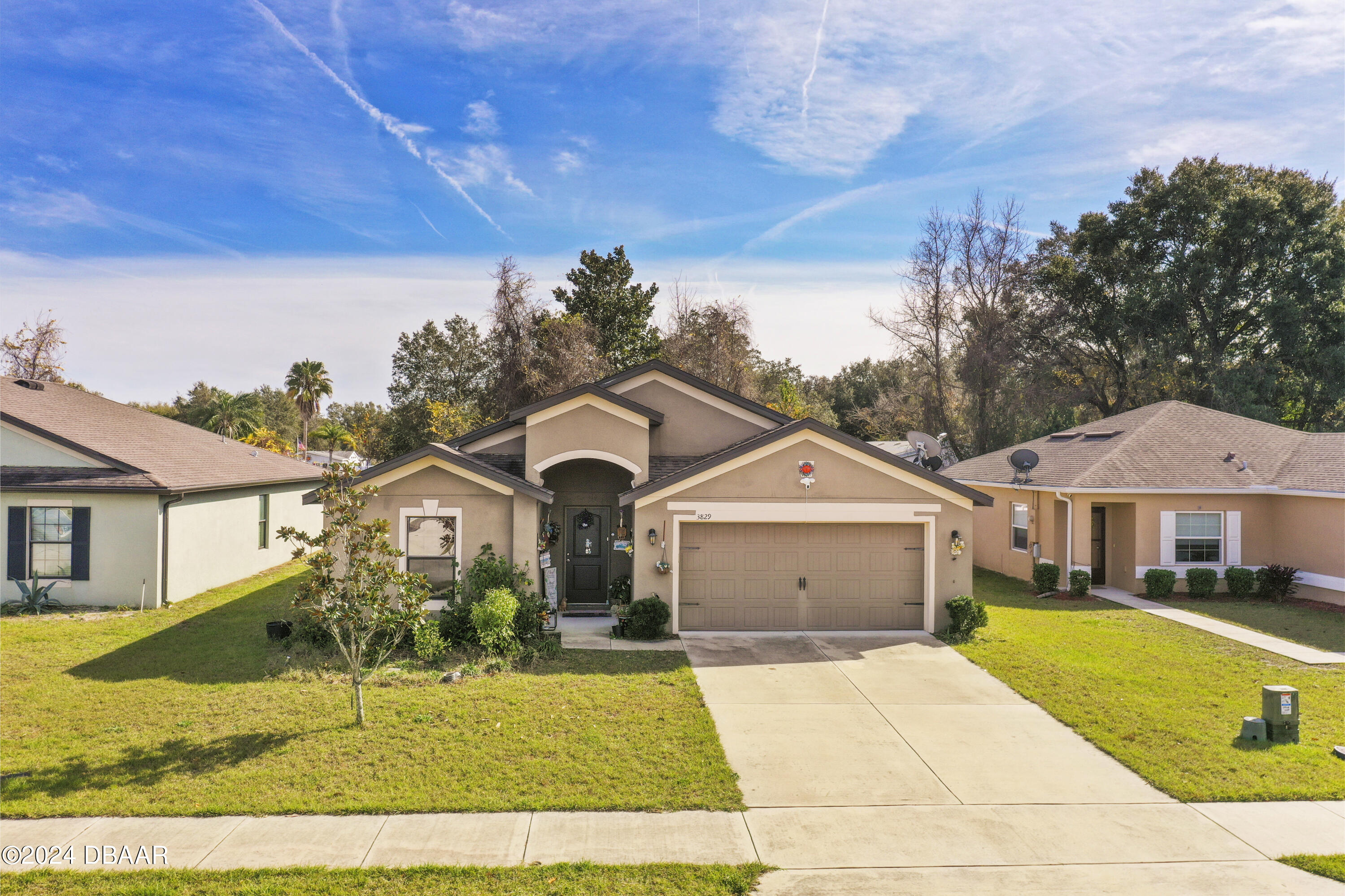 a front view of a house with a yard