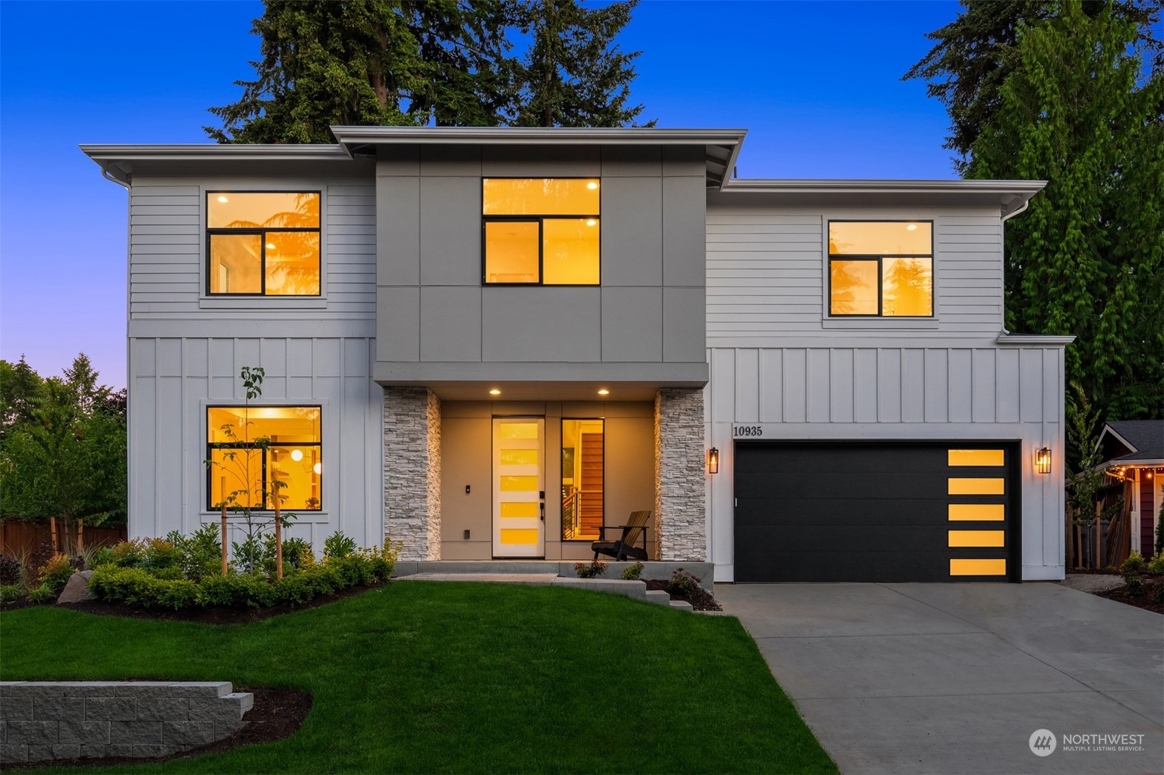 a front view of a house with yard and garage