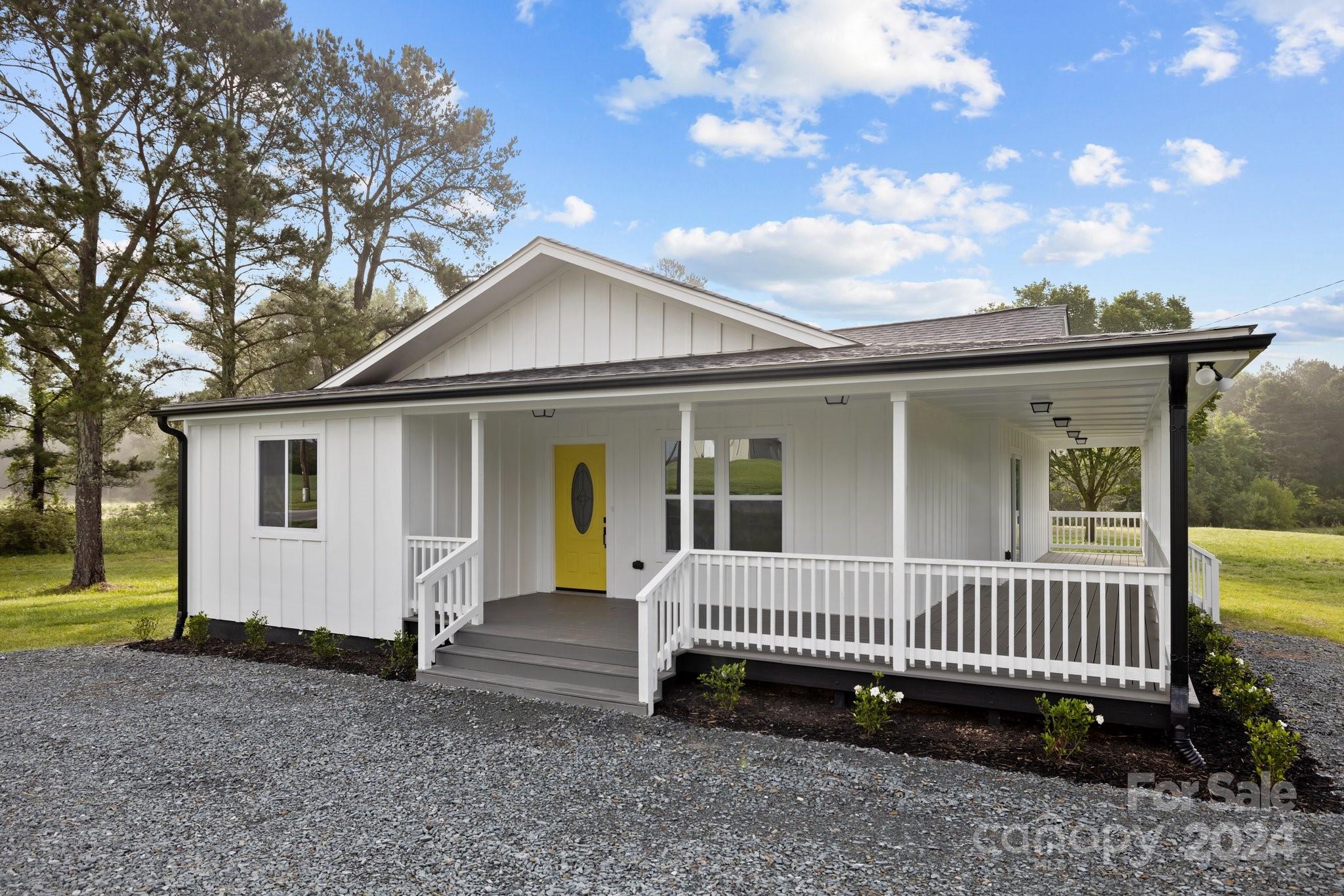 a view of a house with a yard and deck