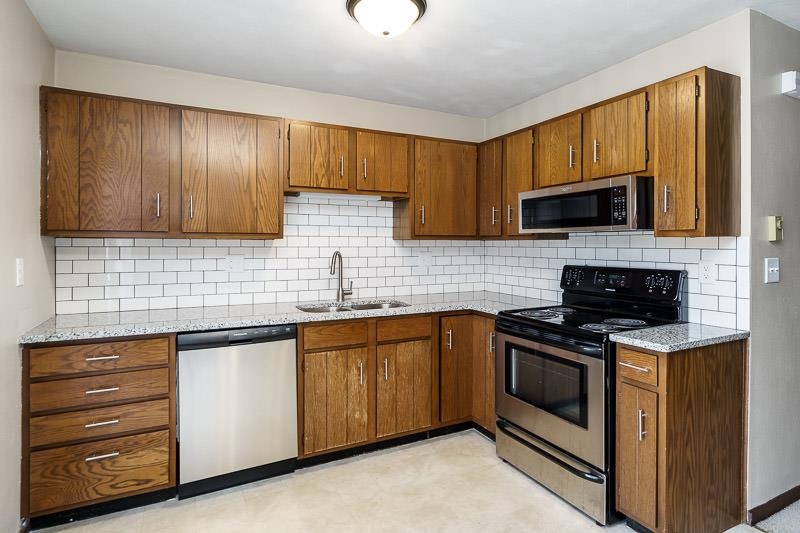 a kitchen with a sink stove and microwave