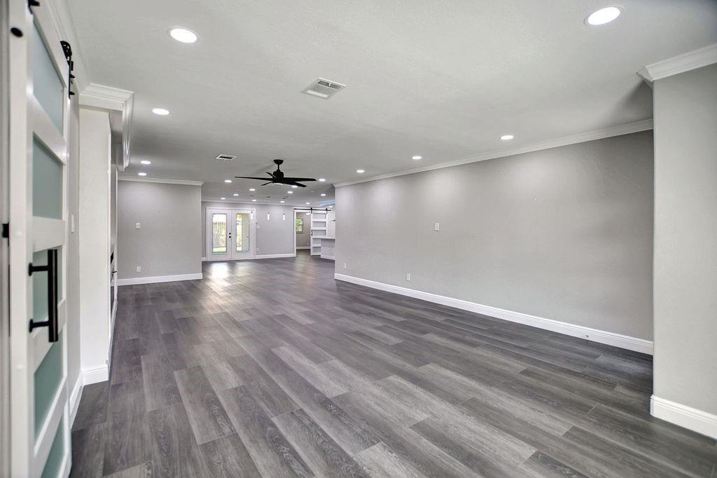 a view of empty room with wooden floor