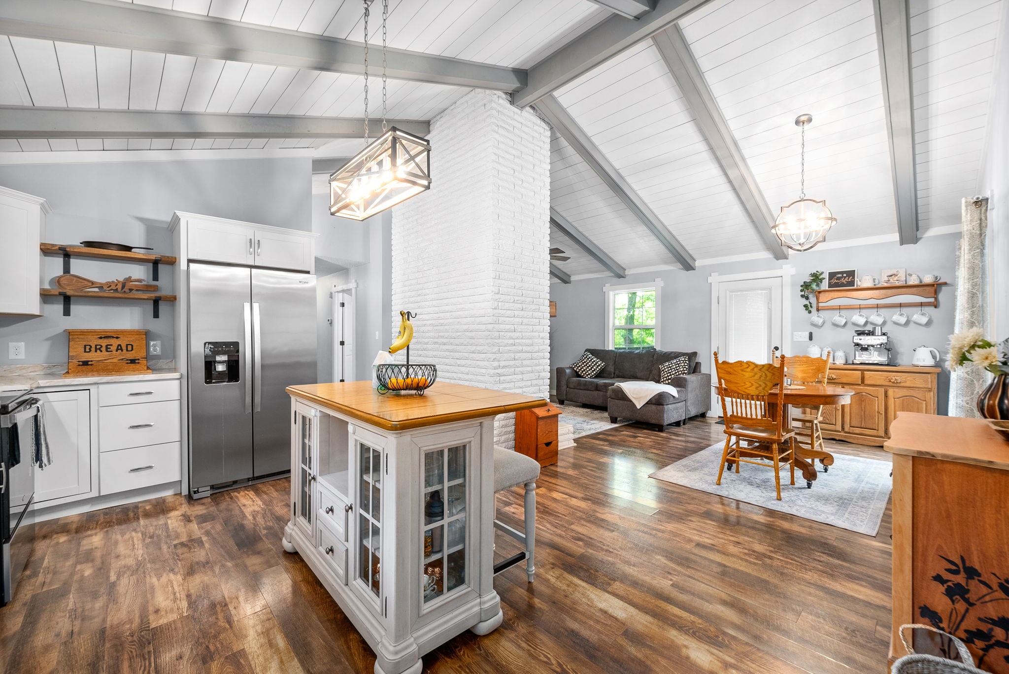 a utility room with cabinets and wooden floor