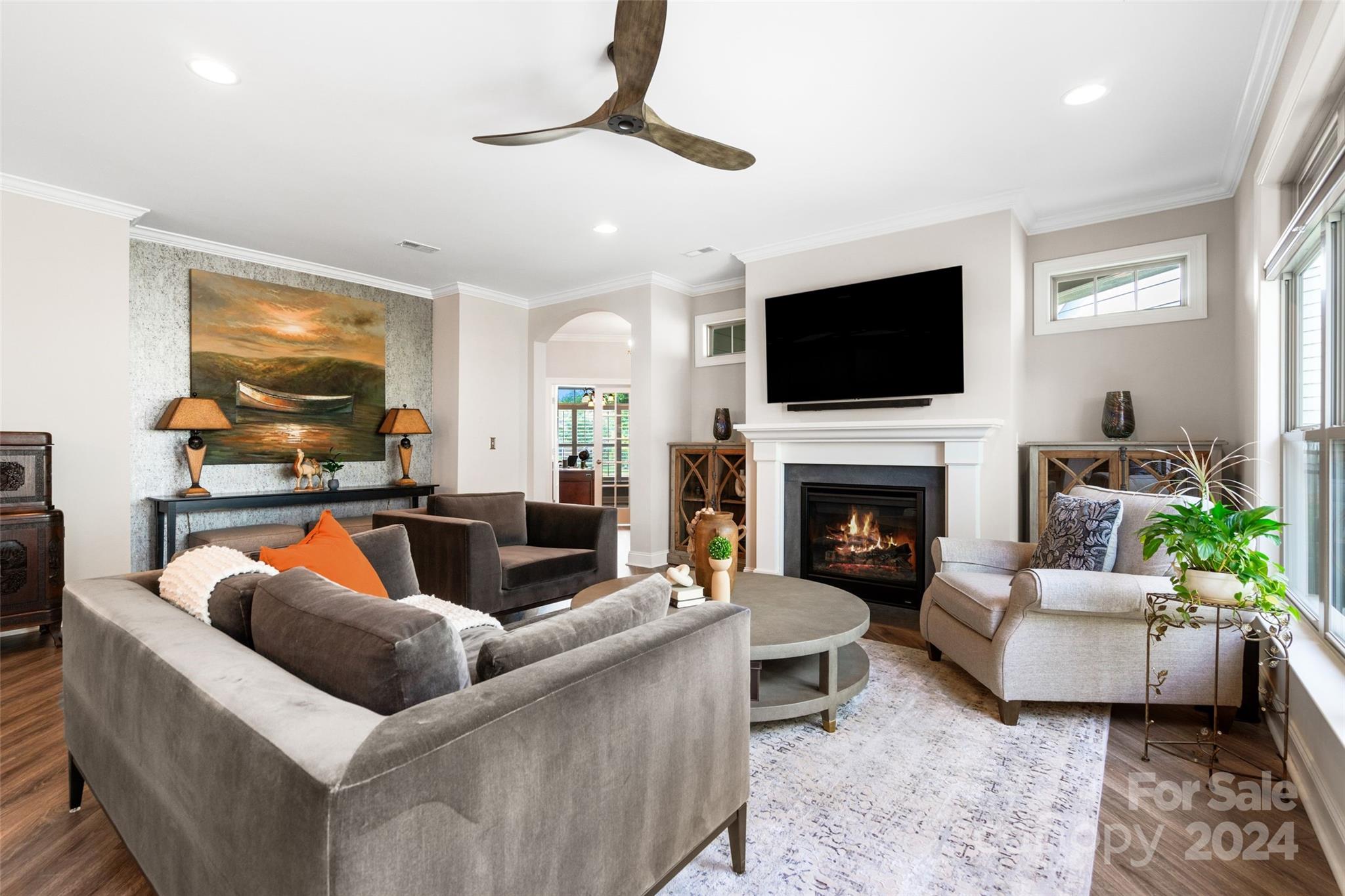 a living room with furniture a fireplace and a flat screen tv