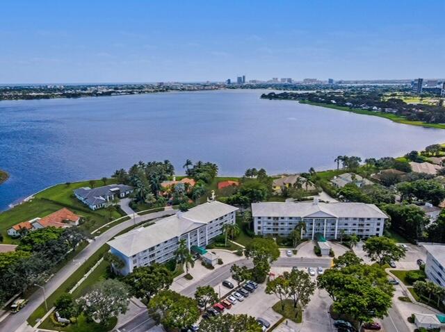 an aerial view of a house with a garden and lake view