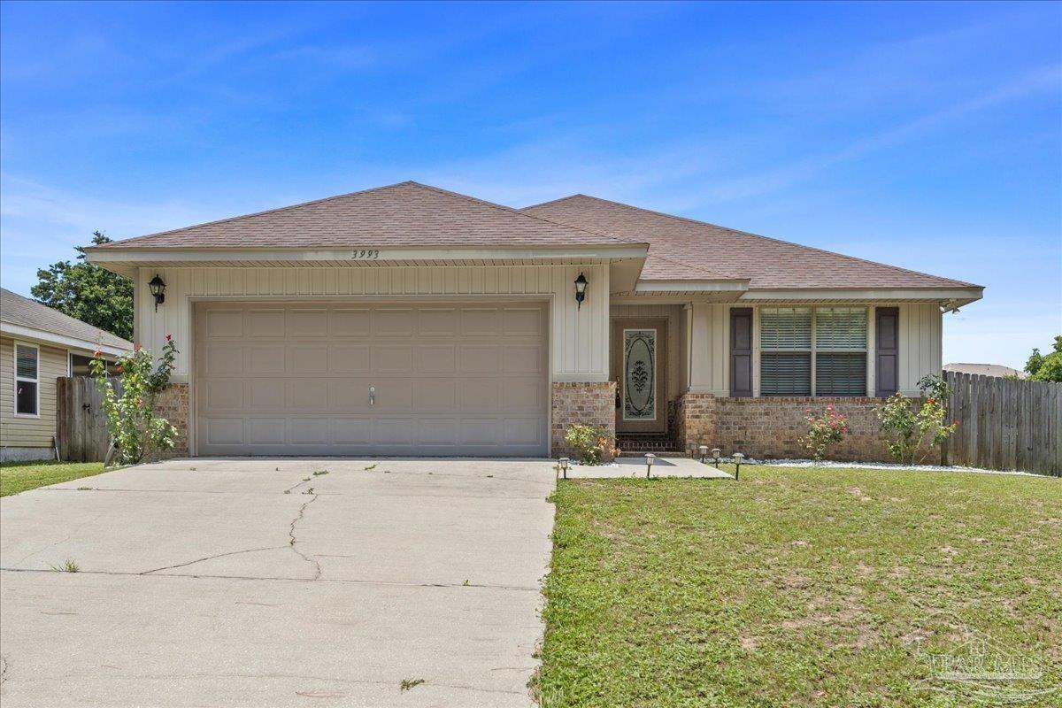 a front view of a house with yard outdoor seating and garage