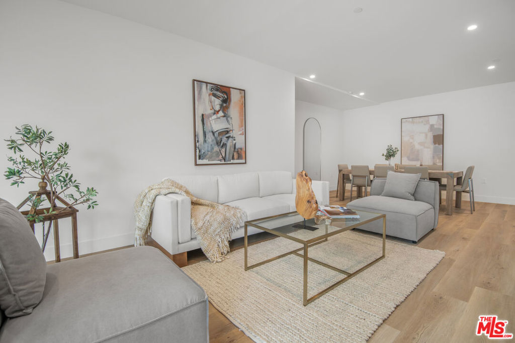 a living room with furniture and a potted plant