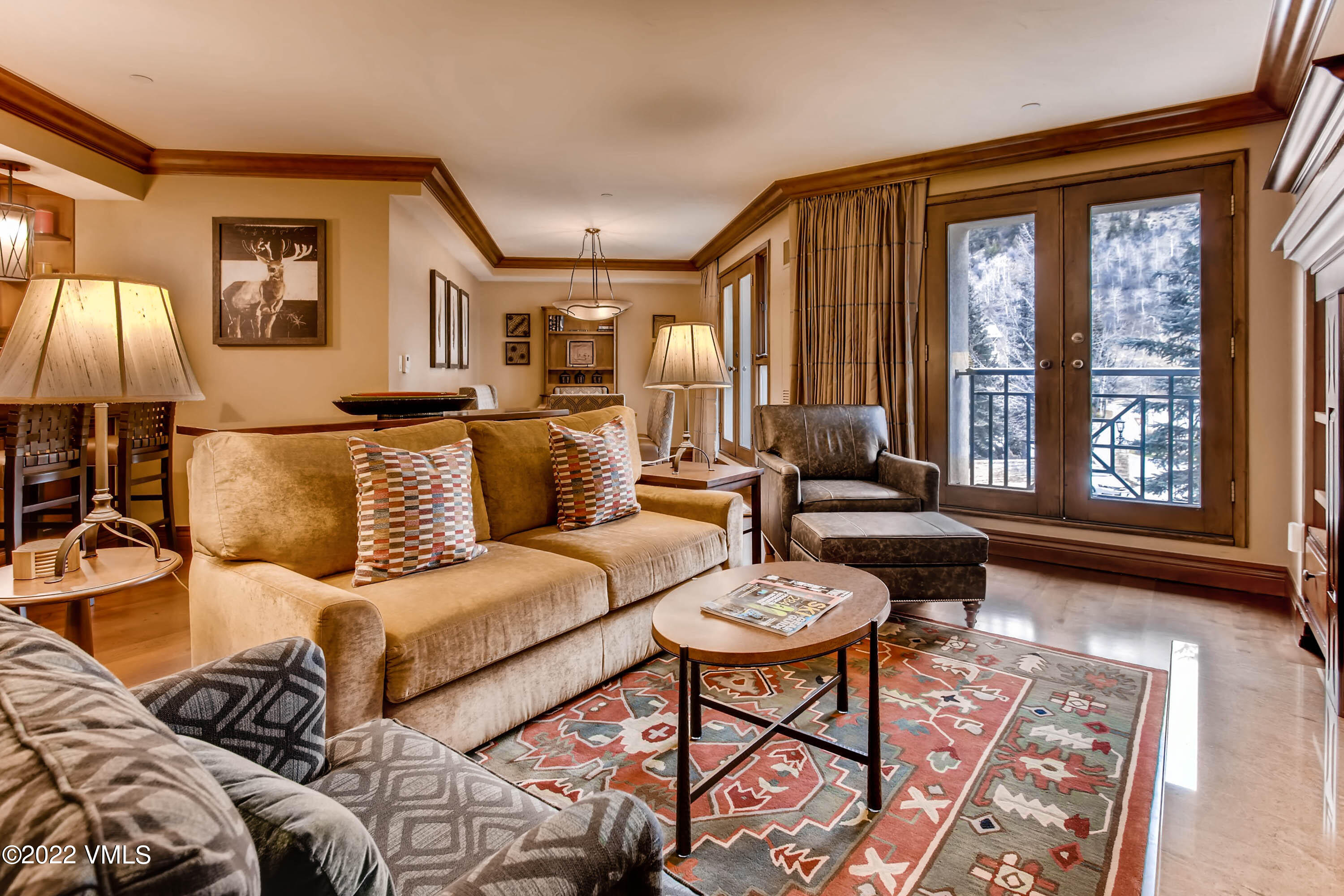 a living room with furniture and floor to ceiling windows