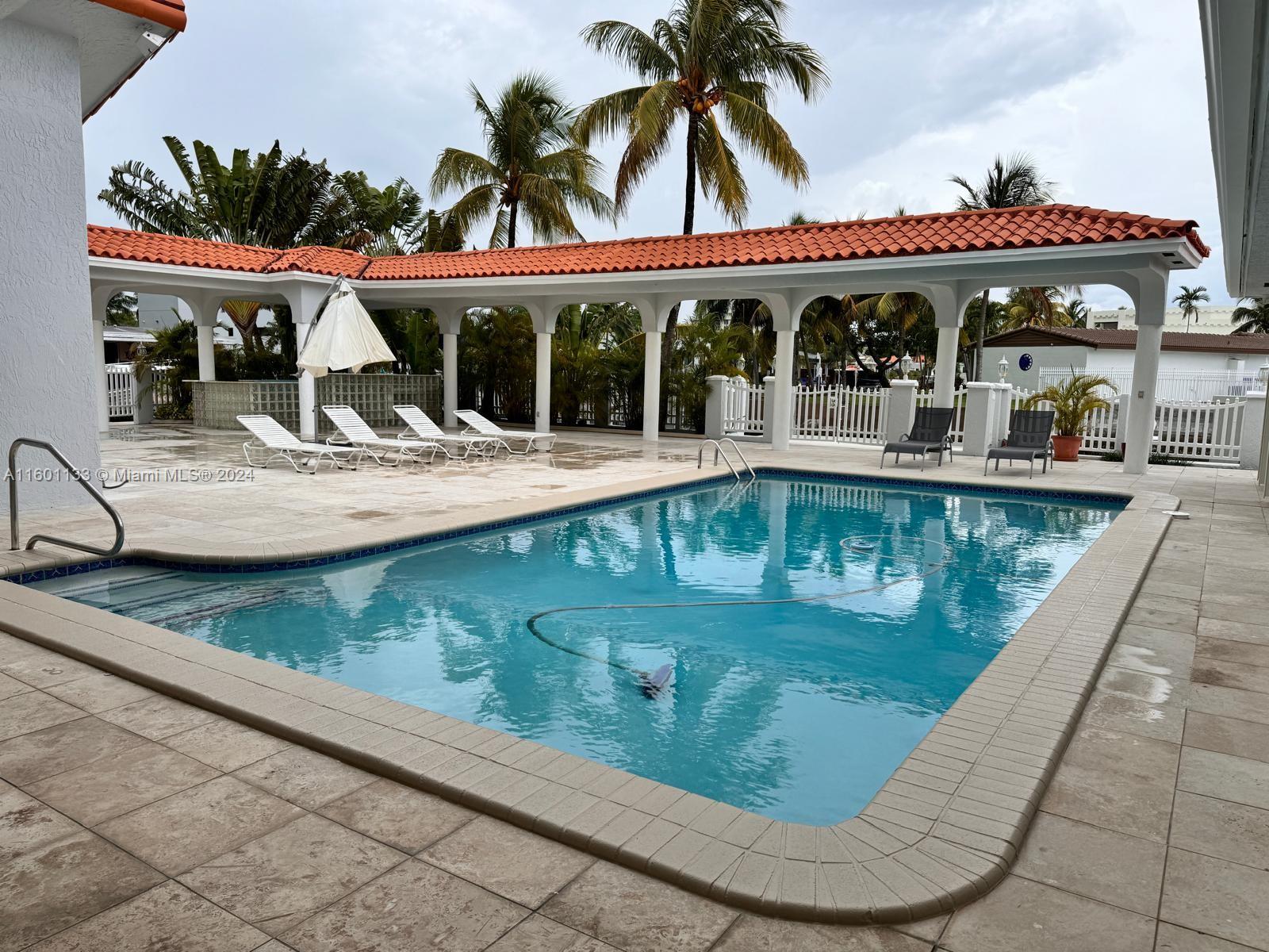 swimming pool view with a garden view