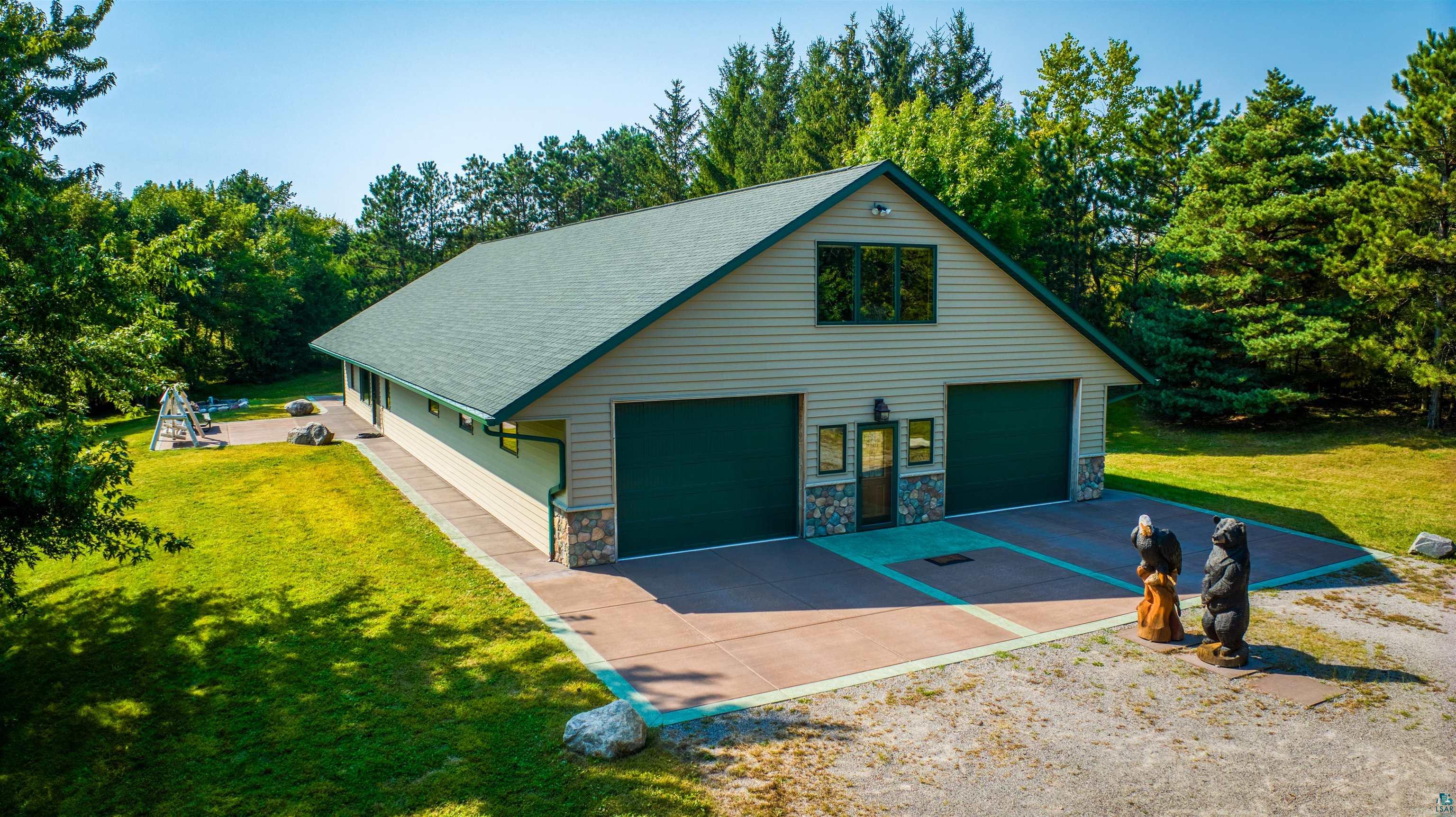 Garage featuring a lawn