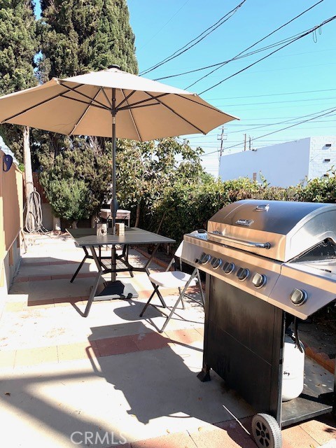 a view of a patio with chairs and umbrellas