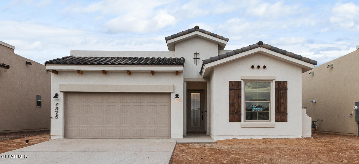 a front view of a house with a garage