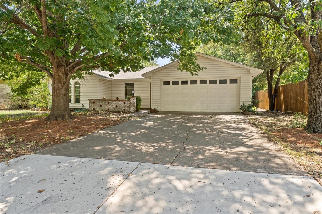 a view of a house with a tree in front of it