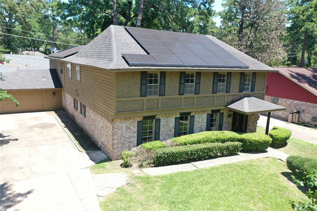 a aerial view of a house with yard and sitting area