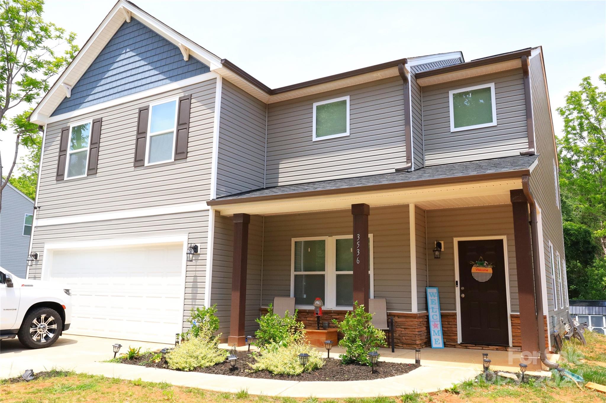 a view of a house with a yard and sitting space